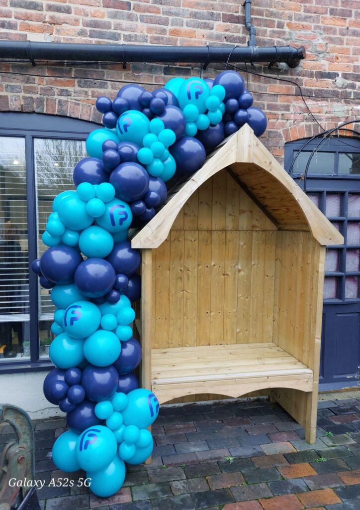 Blue and navy balloon garland decoration installed outside a business for a grand opening event